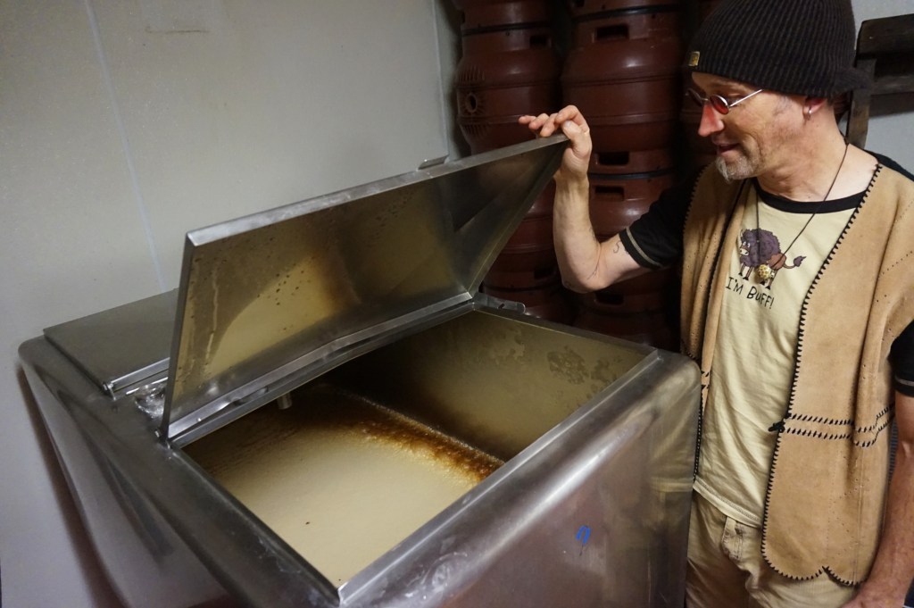 John Crane and an open fermentor at The 3 Legged Crane. Photo: Beerstone.com
